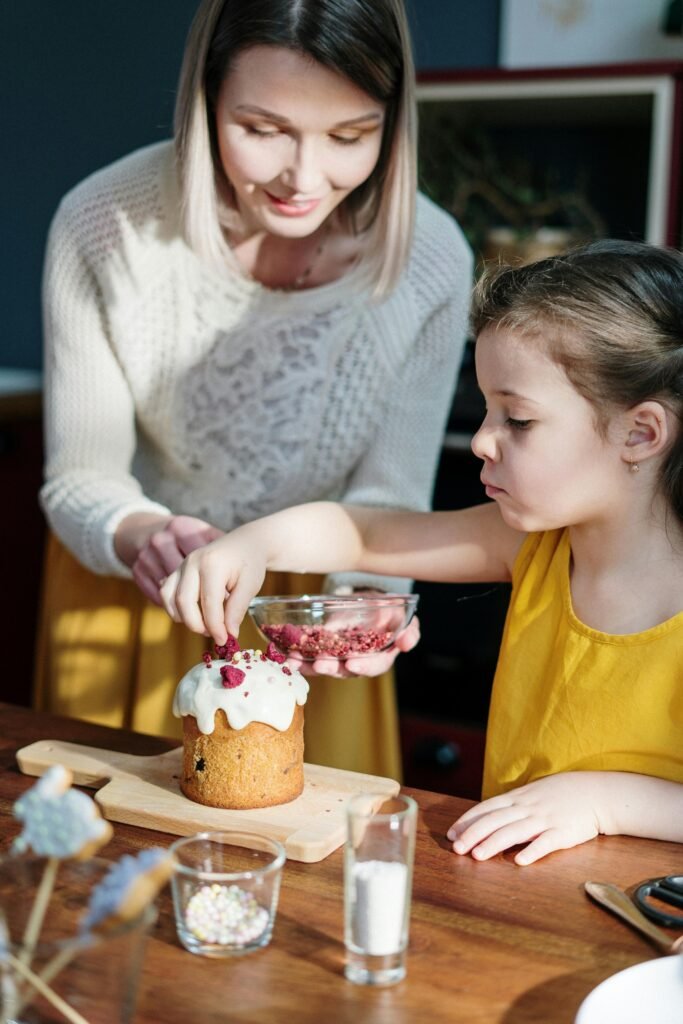 pexels-photo-3992368-3992368 A mother and daughter enjoy decorating an Easter cake in a sunny kitchen.